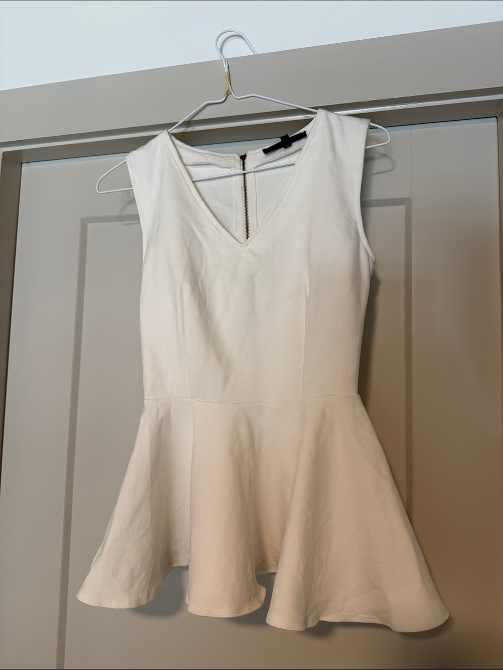 Olivaceous Cream Sleeveless Peplum Top